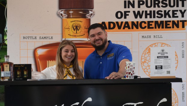 Haley Perros and Noah Baker greet attendees while working the Wilderness Trail Distillery booth during the Great American Brass Band Festival in Danville on Saturday, May 31, 2025. (Photo by Casey Roberts)