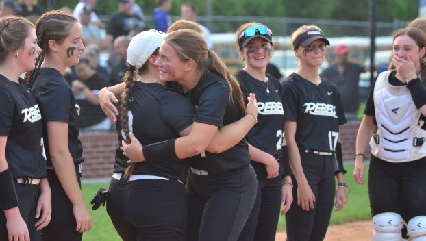 Boyle County seniors Havannah Maddox (facing camera) and Addie Cannon hug as the Lady Rebels celebrate their 12th Region Tournament title. (Photo by Mike Marsee)
