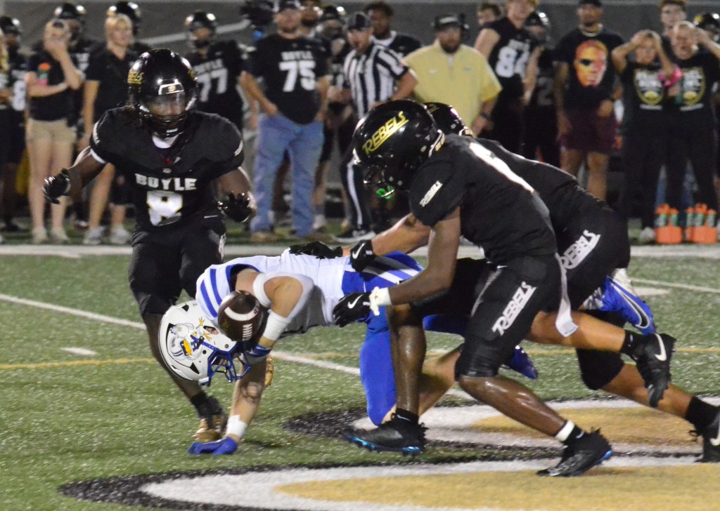 Gabe Williams of Highlands fumbles the ball after being hit by Boyle County's Jax Crowe, back right, and Jakeem Ray, front right, during the fourth quarter Friday. Ray recovered the fumble to set up the deciding touchdown. (Photo by Mike Marsee)